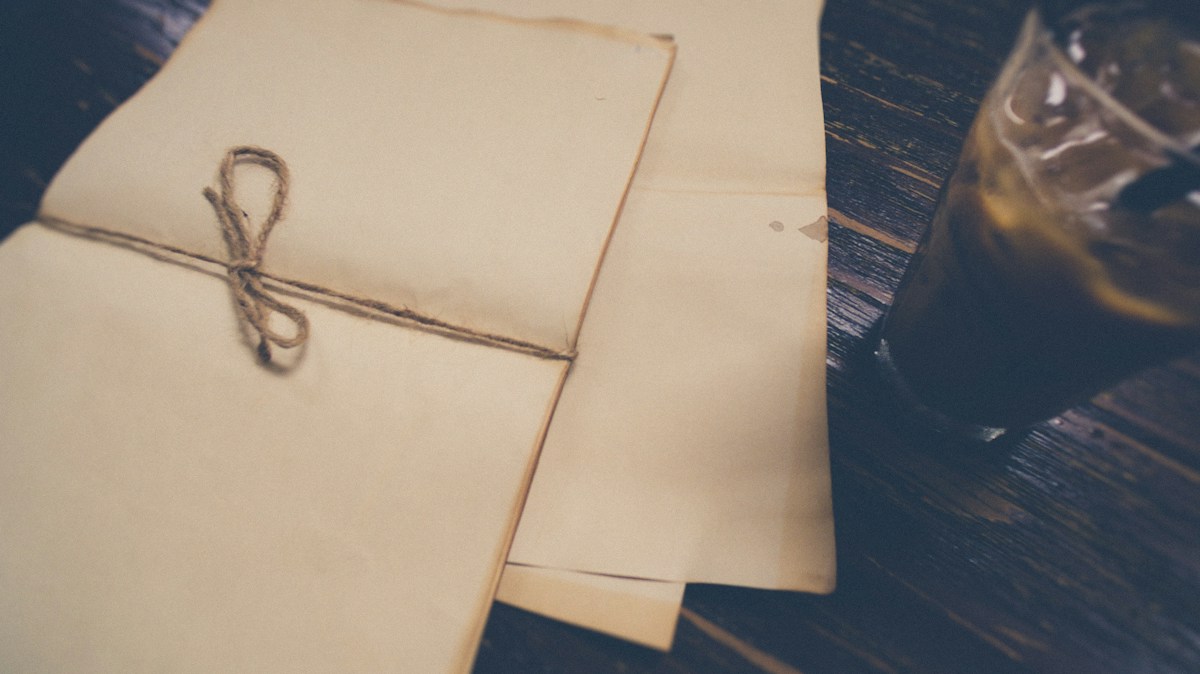 Open brown planner on a wooden table with a pen, highlighting a November event planning checklist for organizers.