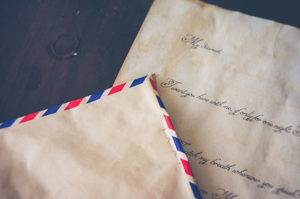 a paper envelope on top of a letter