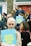 A group of people gathered outside with signs that read 'TRUTH JUSTICE LOVE' in bold yellow letters on a blue background. The crowd includes a diverse mix of individuals, some holding cameras, with expressions ranging from focused to contemplative. The background features red and blue doors with brick walls.