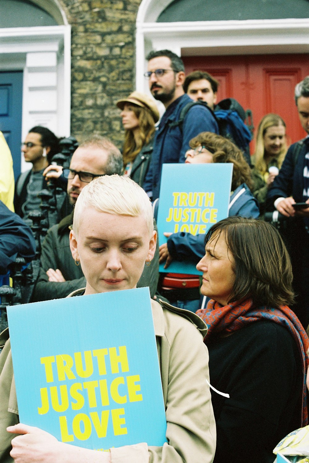 woman holding Truth Justice Love poster