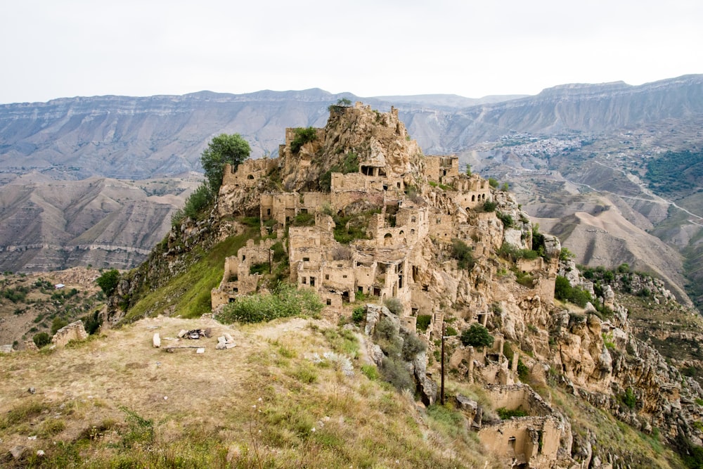 beige wrecked houses on mountain