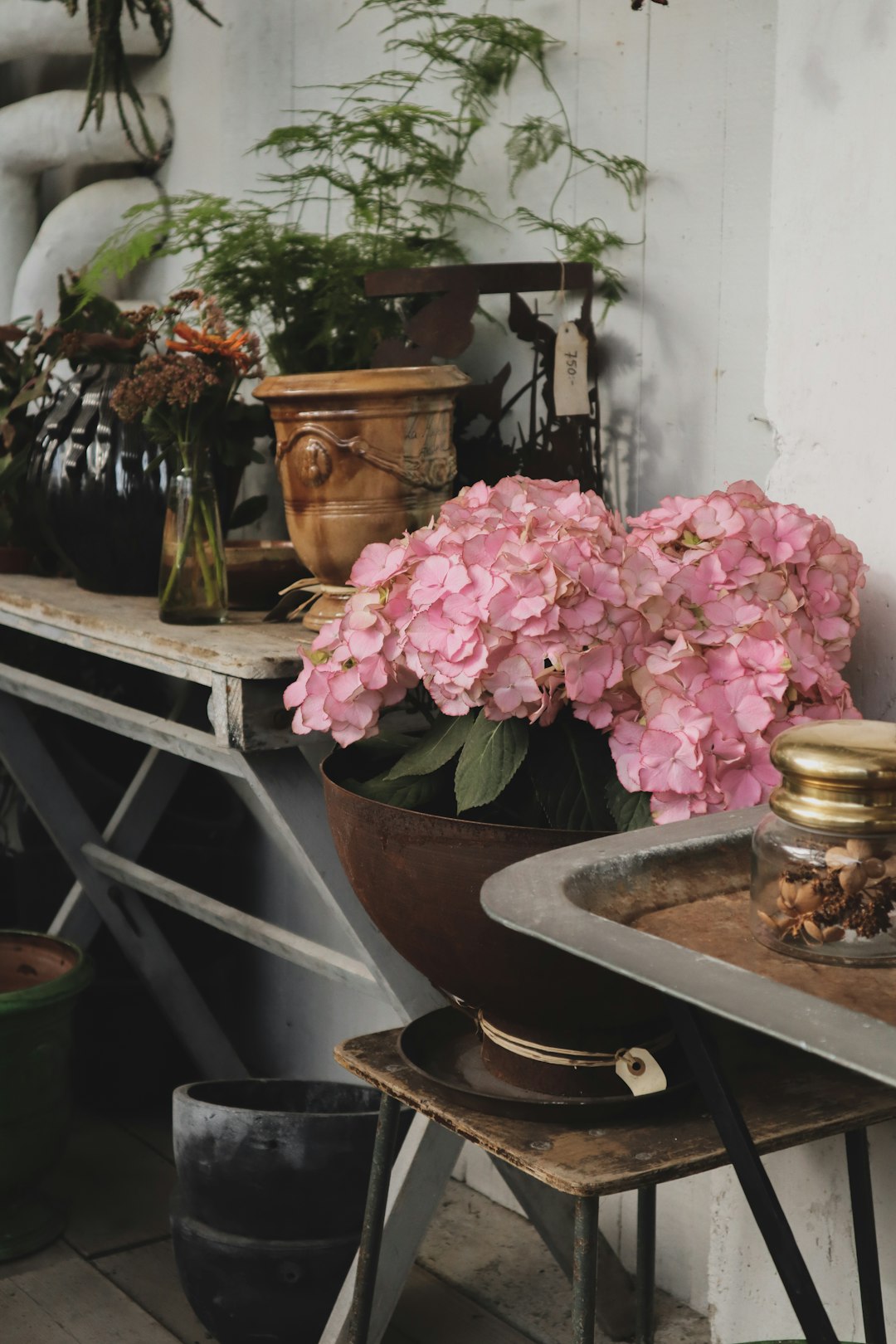 pink flowers in pot near console table