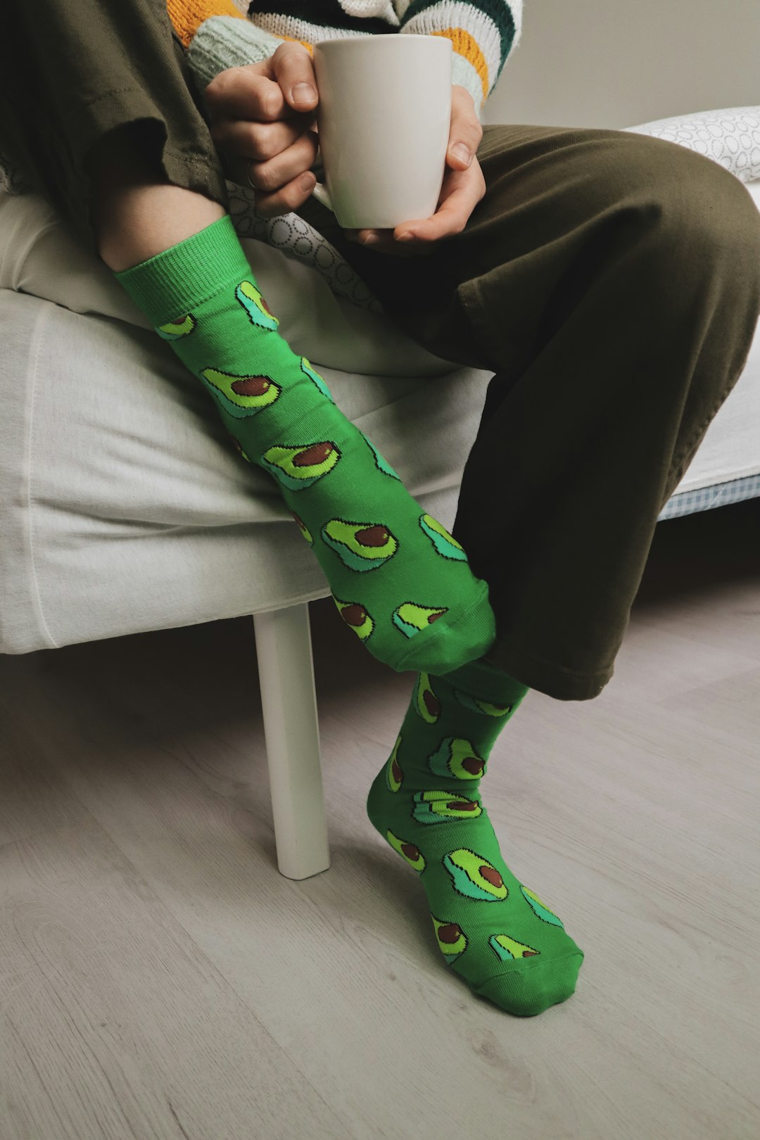 person wearing pair of green-and-red foot sock