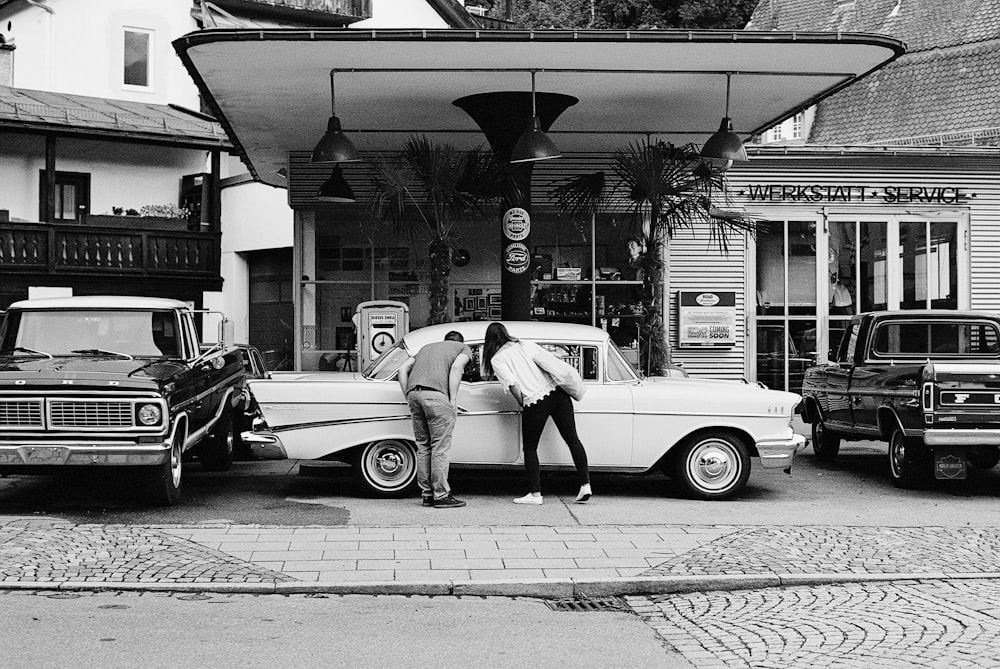 man and woman standing near car