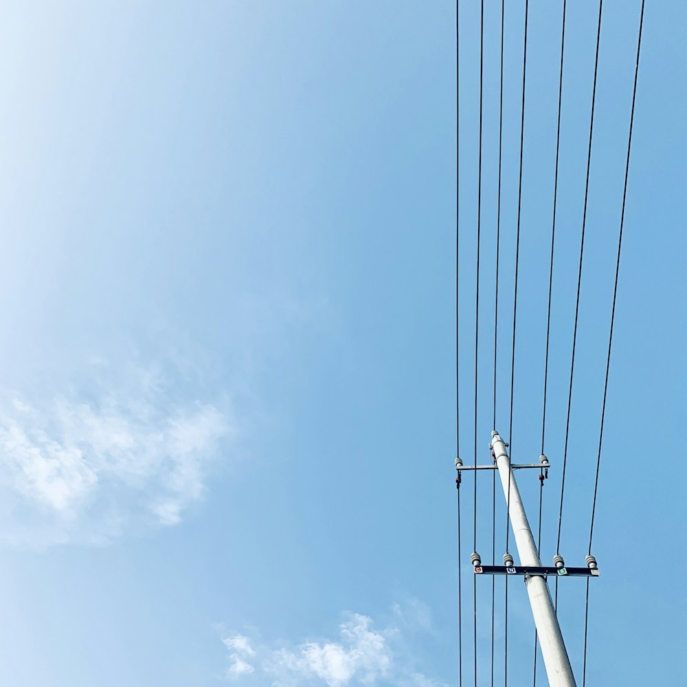 gray post with electrical wires during day