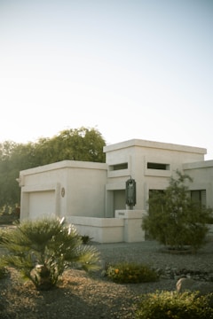 Wide shot of a commercial building exterior featuring sleek stucco work under bright Arizona sunlight.