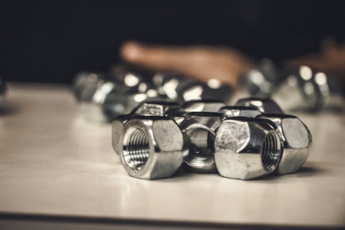 A collection of different types of clinch nuts displayed on a white background.