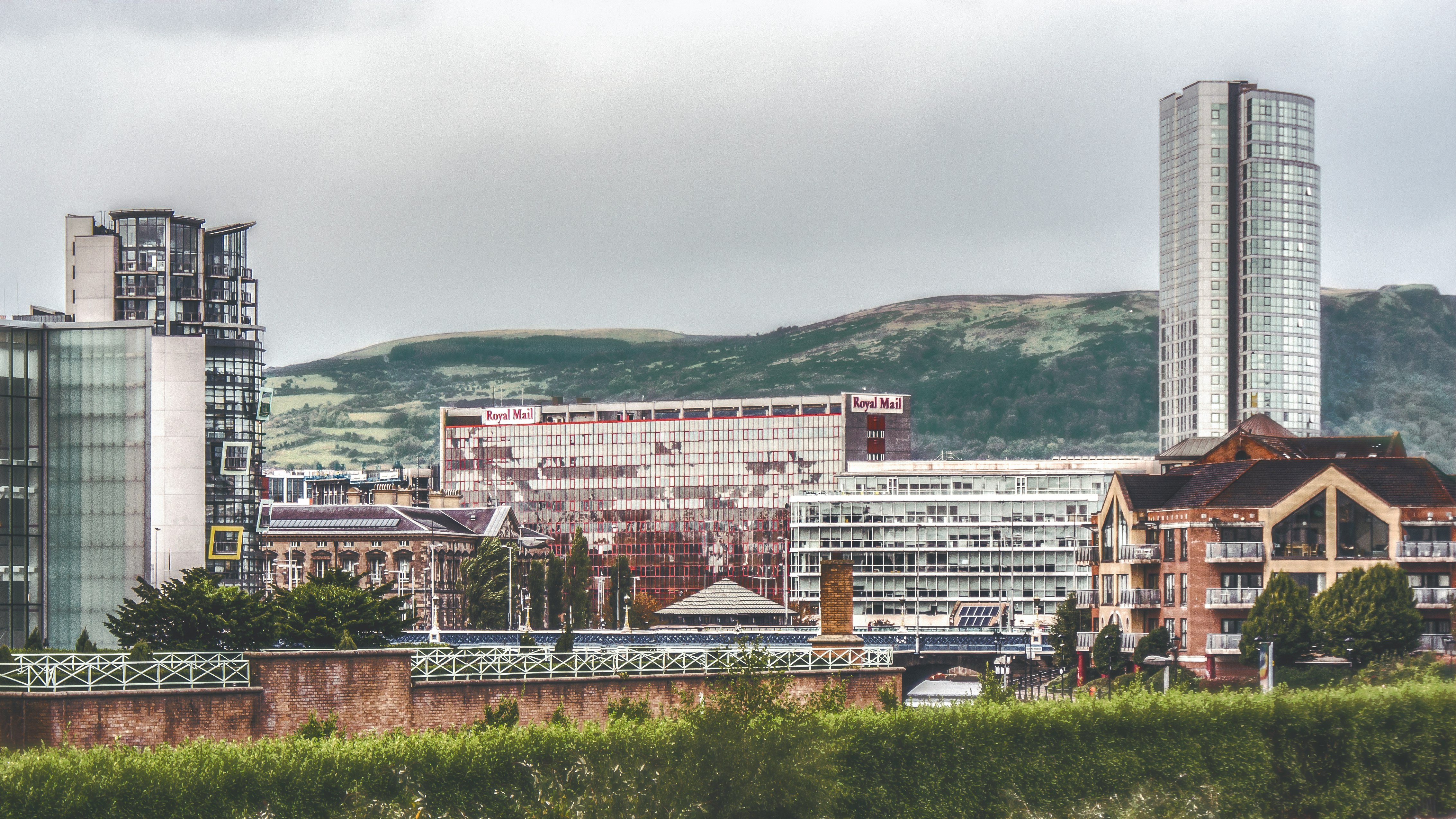 city with high-rise buildings viewing mountain during daytime