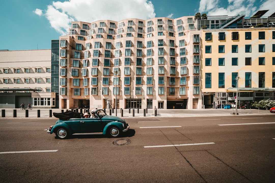 green Volkswagen Beetle on road during daytime