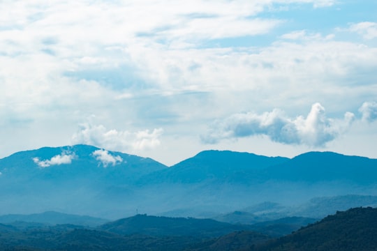 silhouette of mountains under cloudy sky in Kerala India