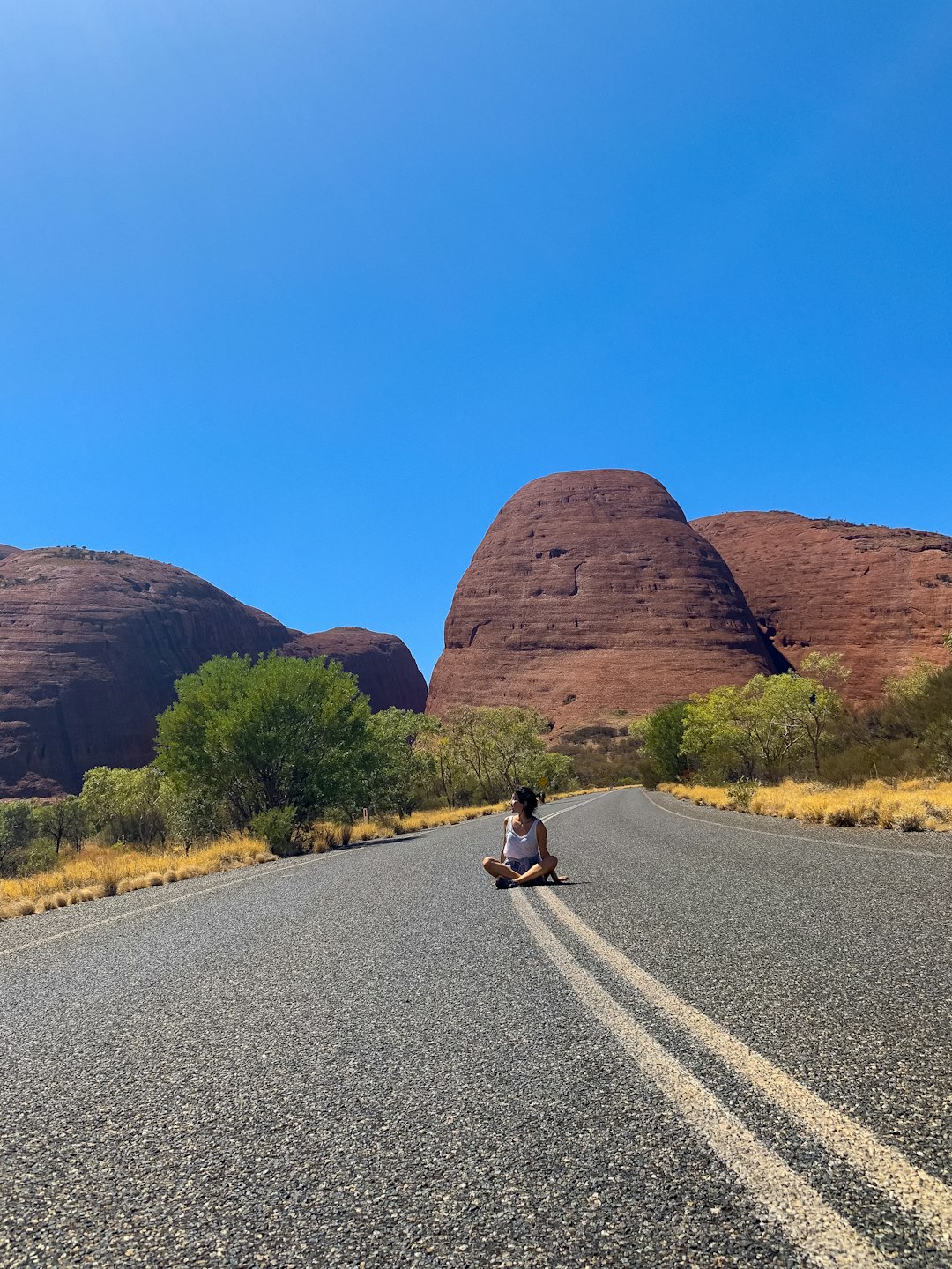 woman sitting on road