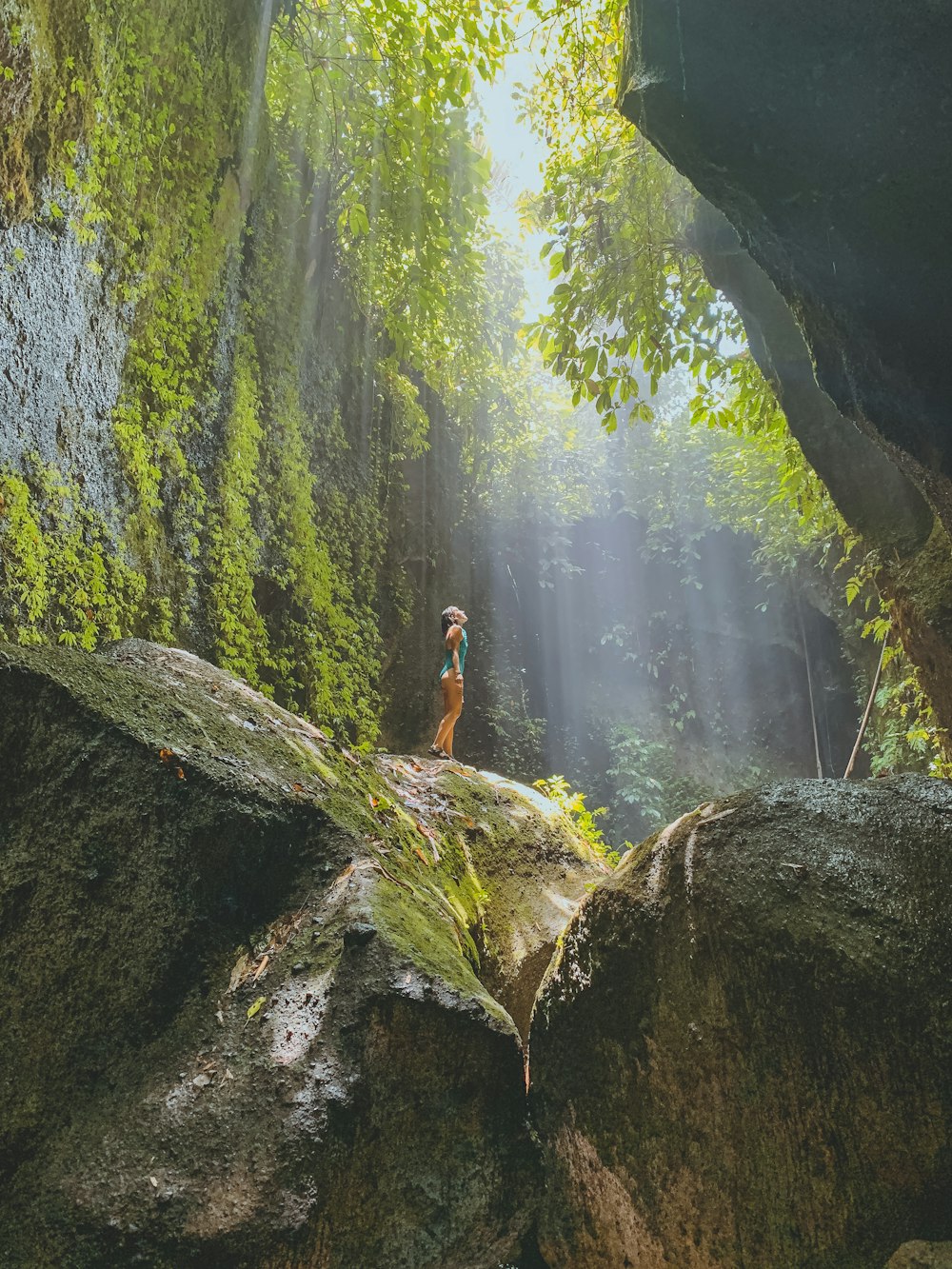 person standing on rock formation during daytime