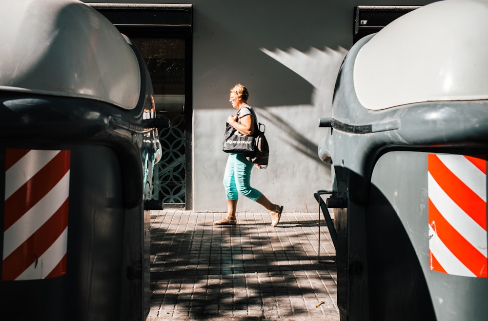 woman walking on pavement during daytime