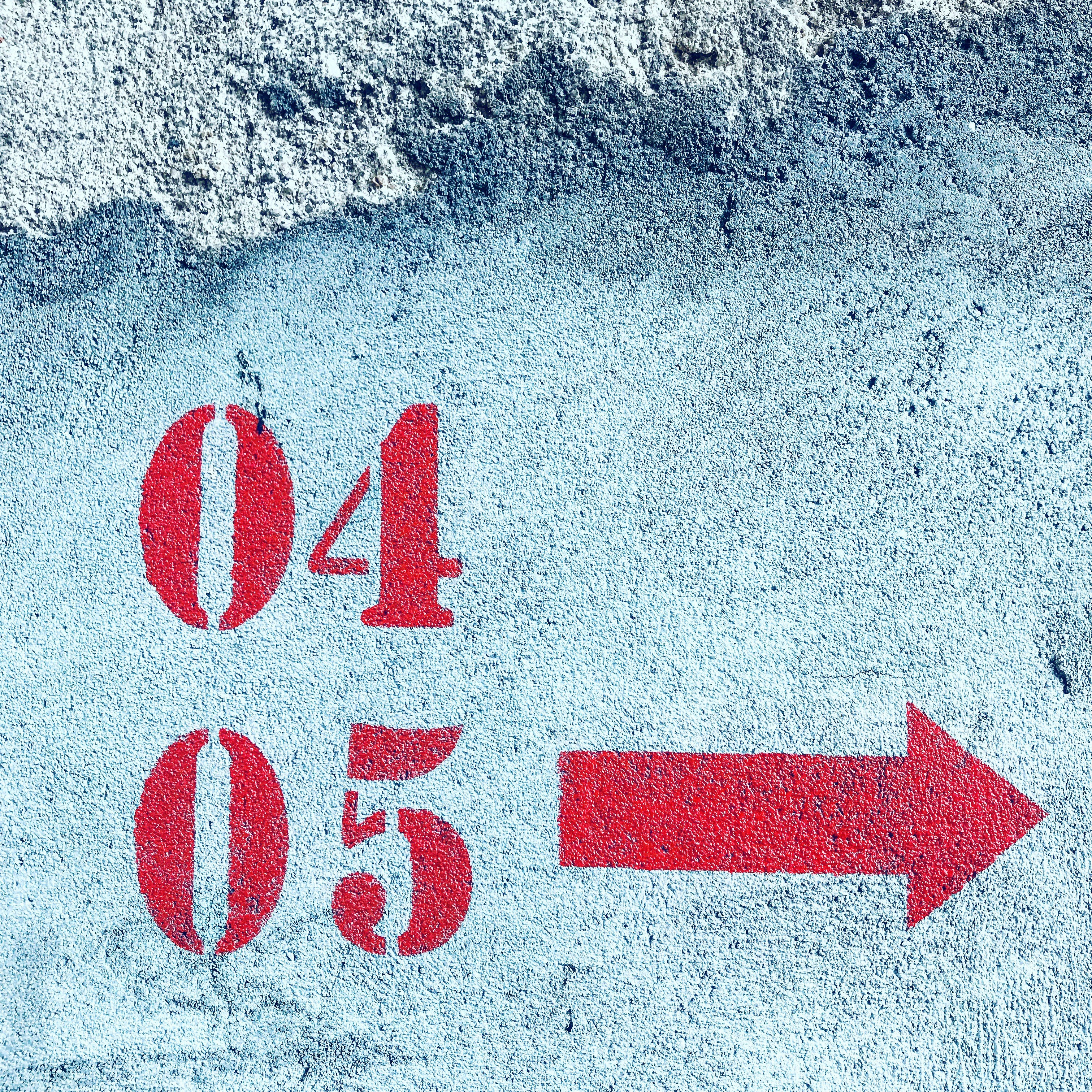 A red arrow pointing to the left on a concrete surface photo – Free Red ...