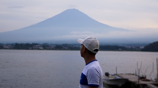 man in white T-shirt wearing gray cap in Mount Fuji Japan