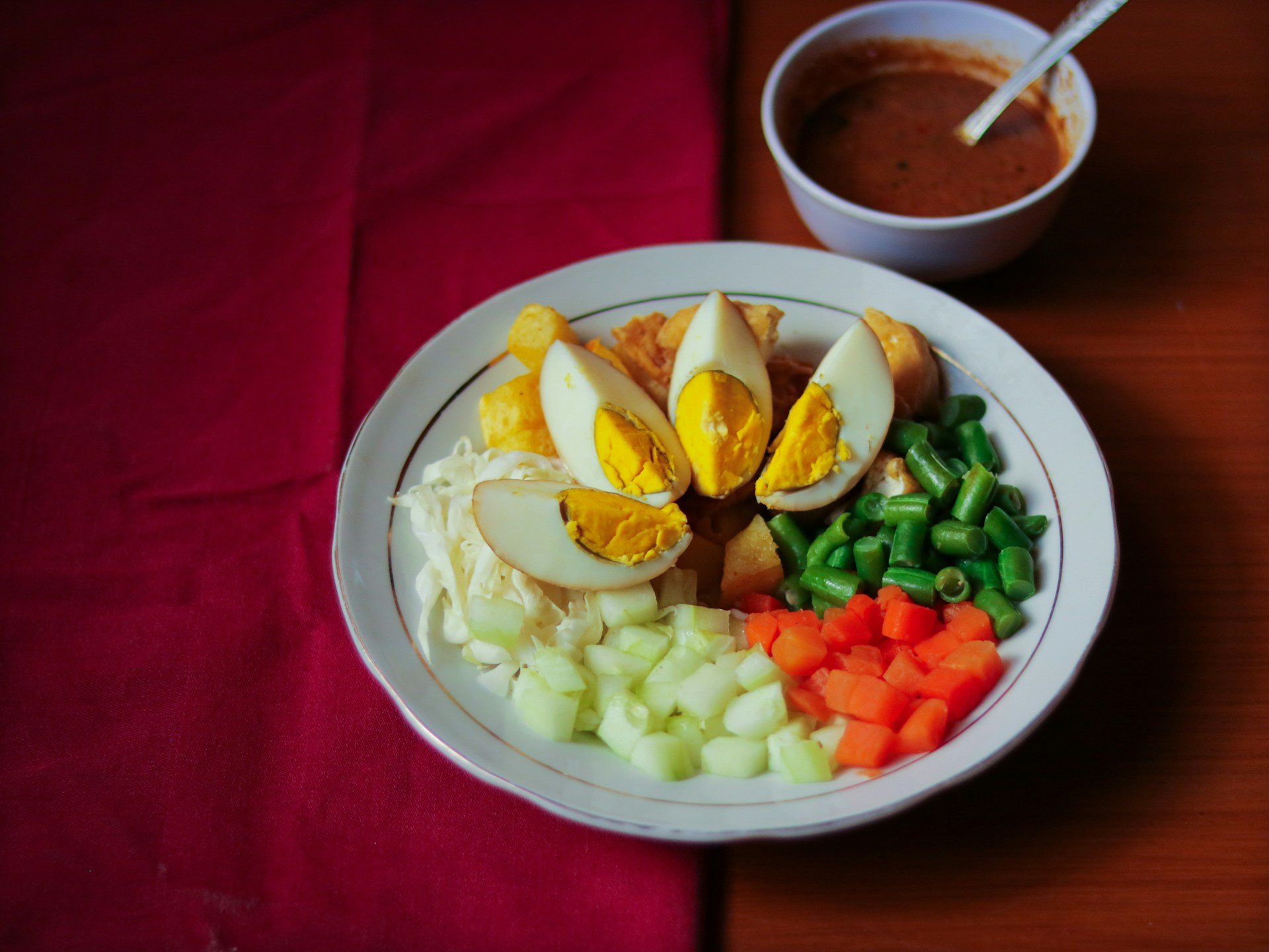 sliced veggies and egg on white ceramic plate