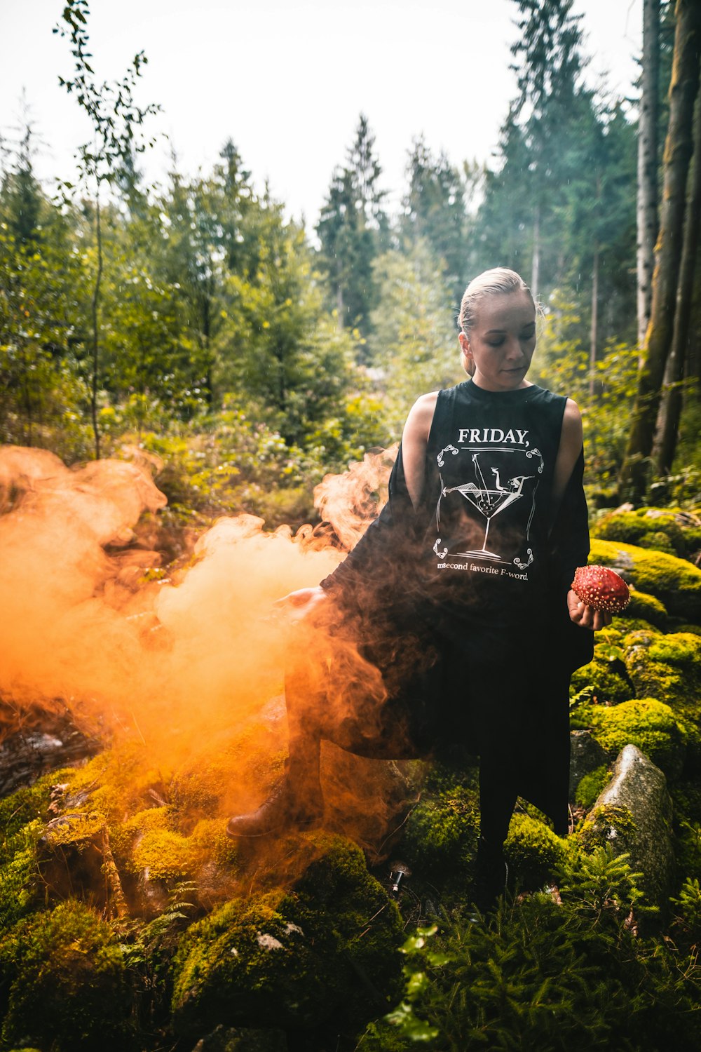 woman wearing black and white Friday-printed shirt beside orange smoke