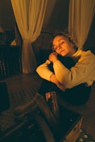 A cozy indoor scene with a person relaxing in comfortable attire.