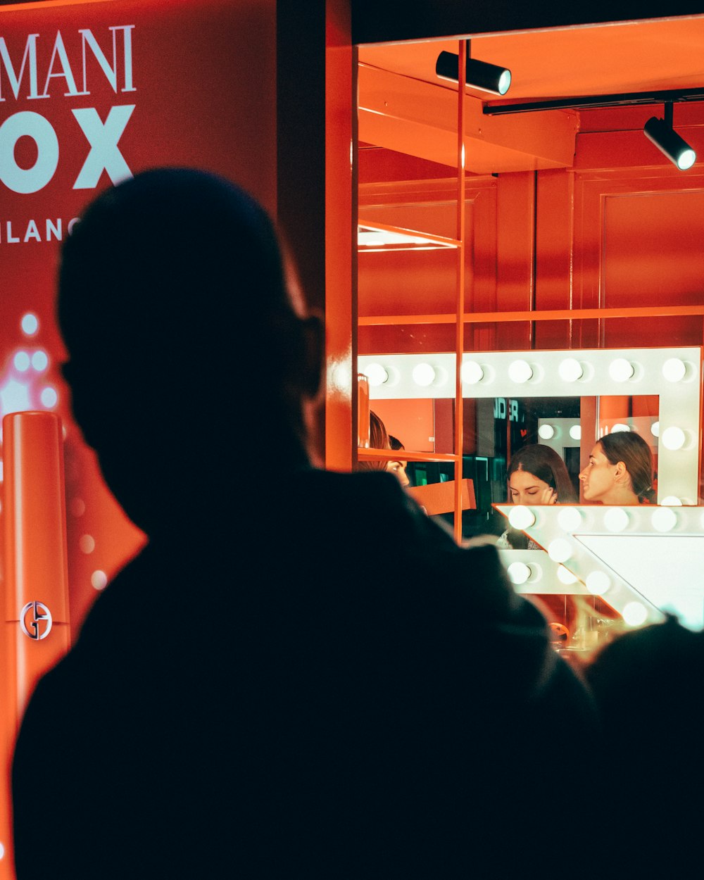 a man looking in a mirror in a store