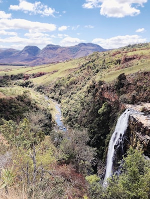 waterfalls under blue sky in high-angle photo