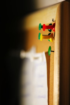 several needle pins on cork board