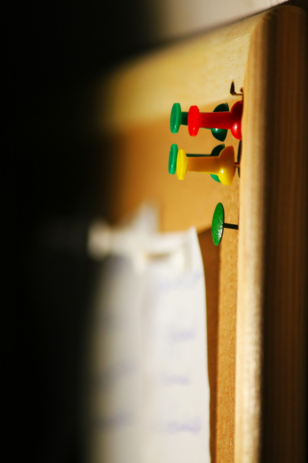 several needle pins on cork board