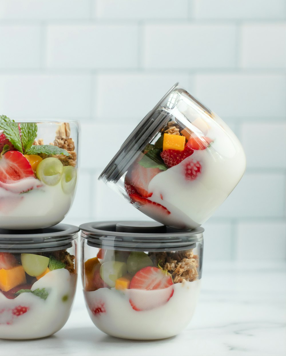 four assorted fruits in jars