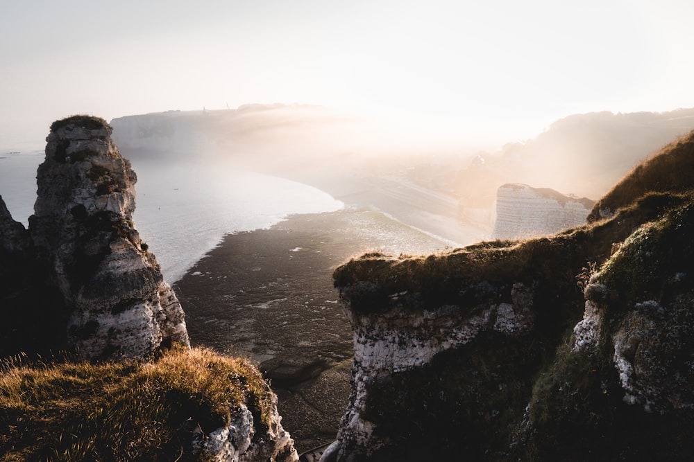 cliff near body of water during daytime