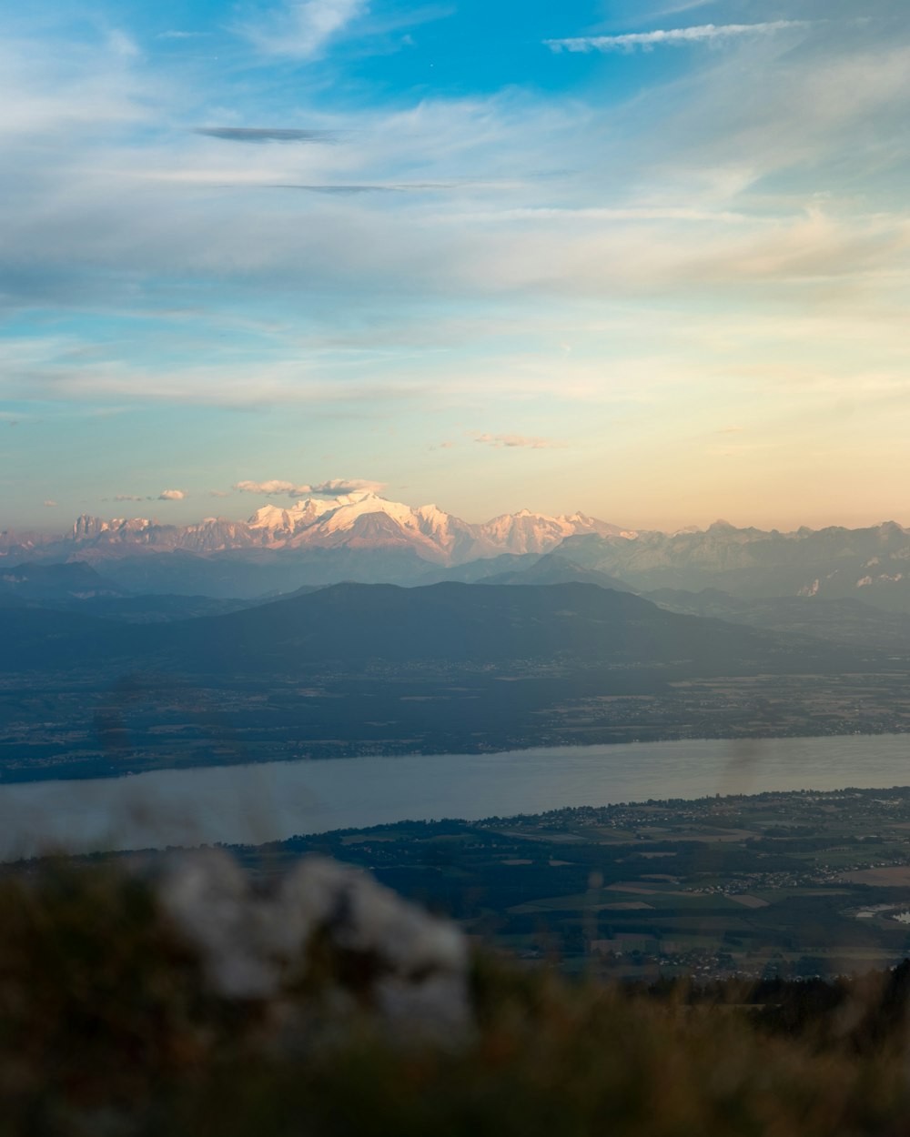 a view of a mountain range with a lake in the foreground