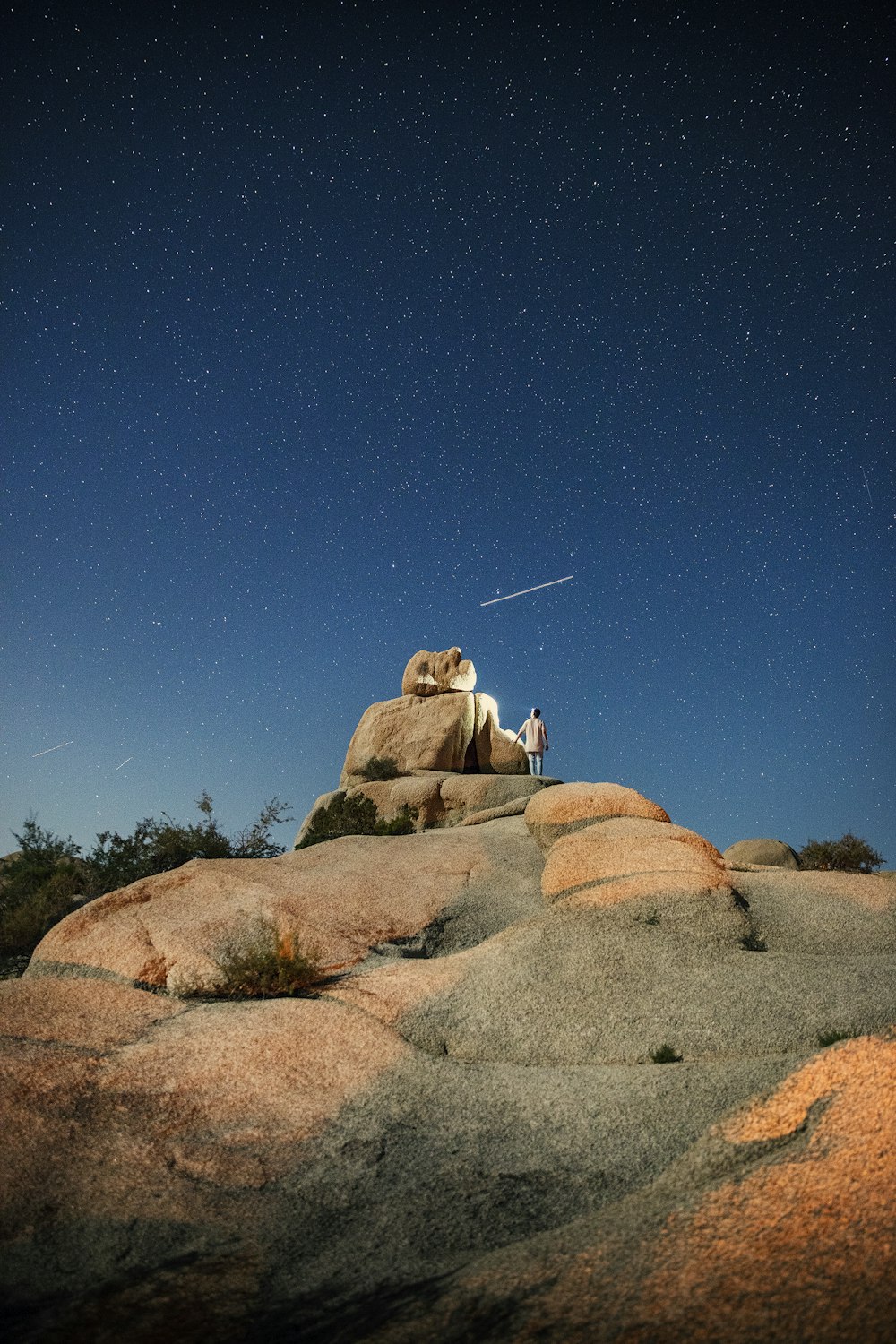 person standing on cliff at night