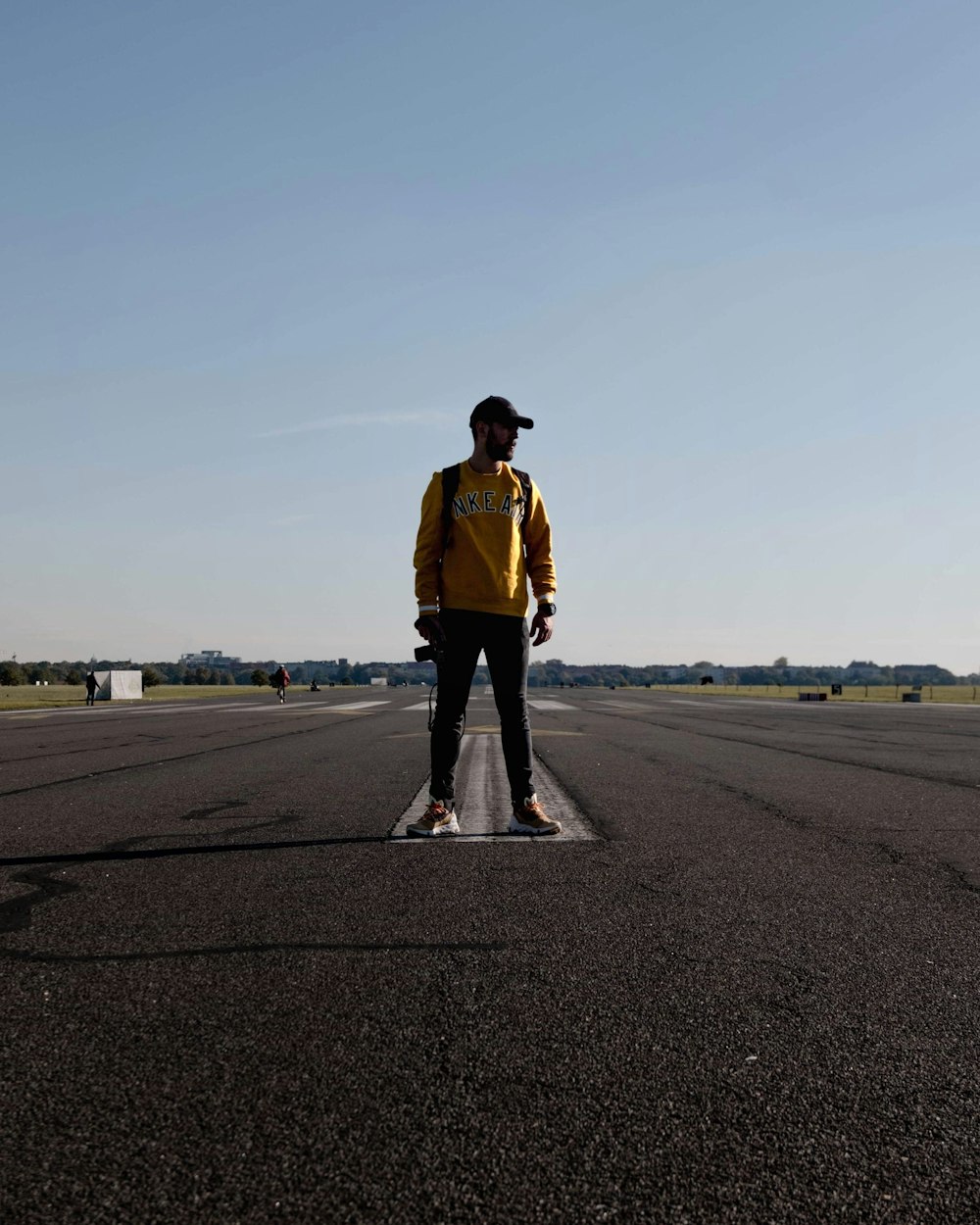 man standing on road during day