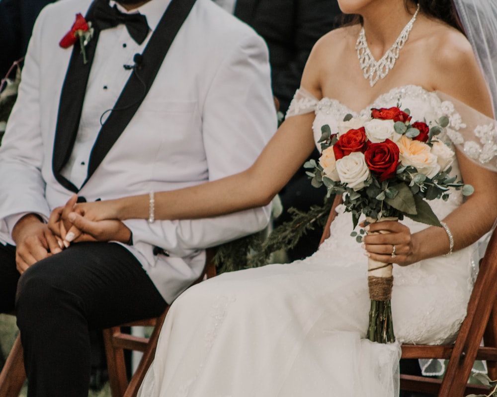 sitting woman wearing white strapless wedding dress beside man