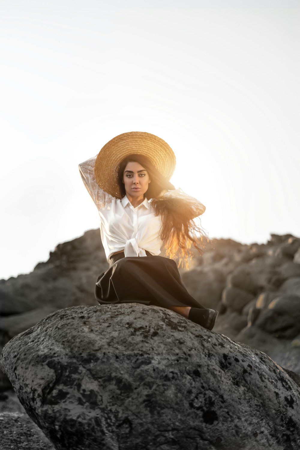 glaring woman sitting on rock