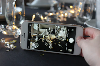 A close-up of a hand holding a smartphone displaying a wine purchase confirmation screen.