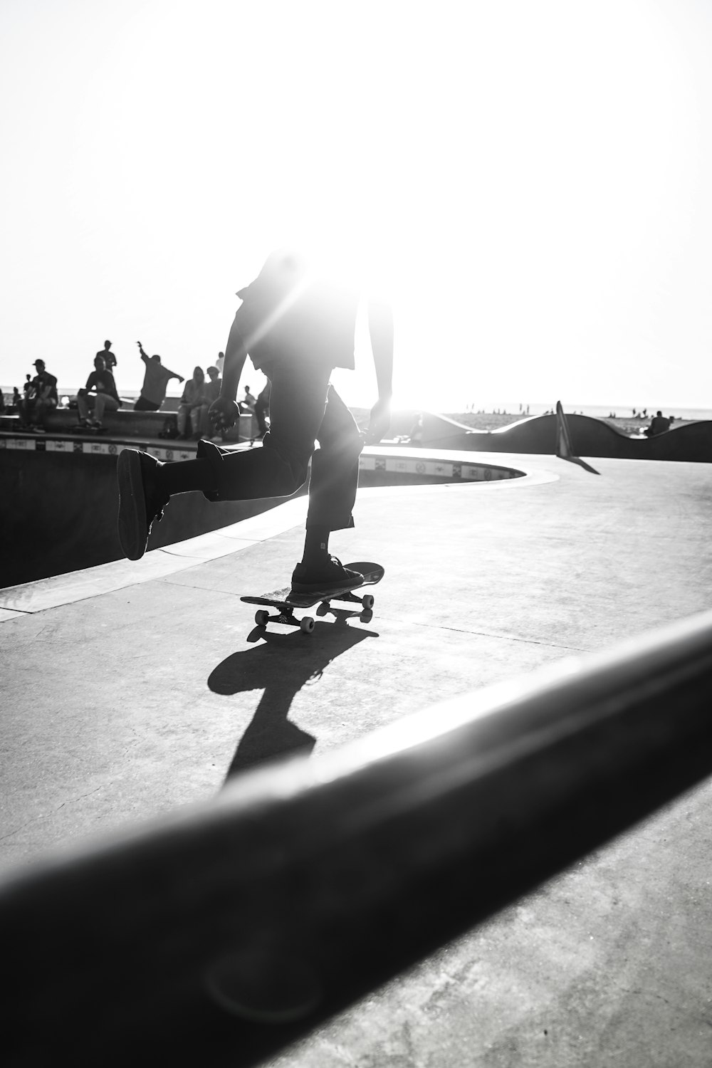 person riding skateboard on grayscale photography