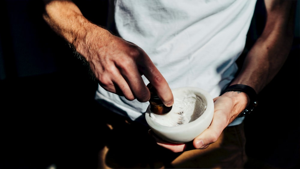 man holding white bowl