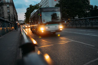 white bus on road at night