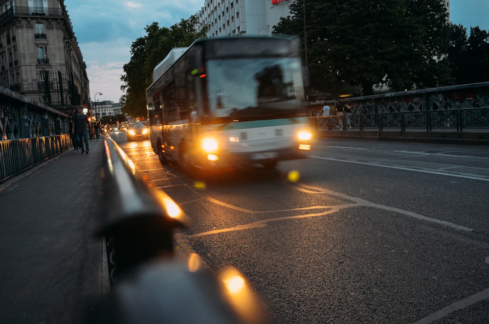 white bus on road at night