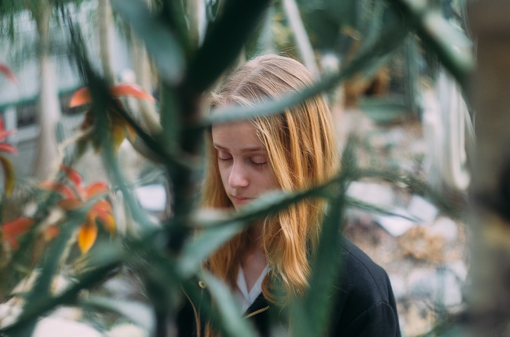 woman behind plant