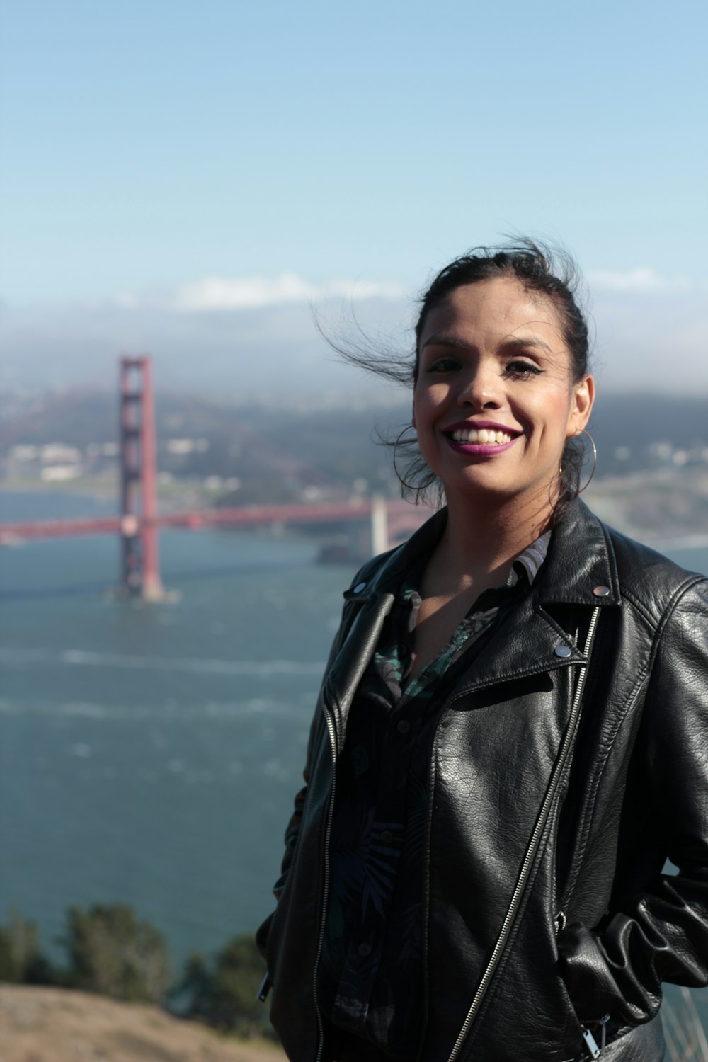 woman standing near Golden Gate bridge during daytime