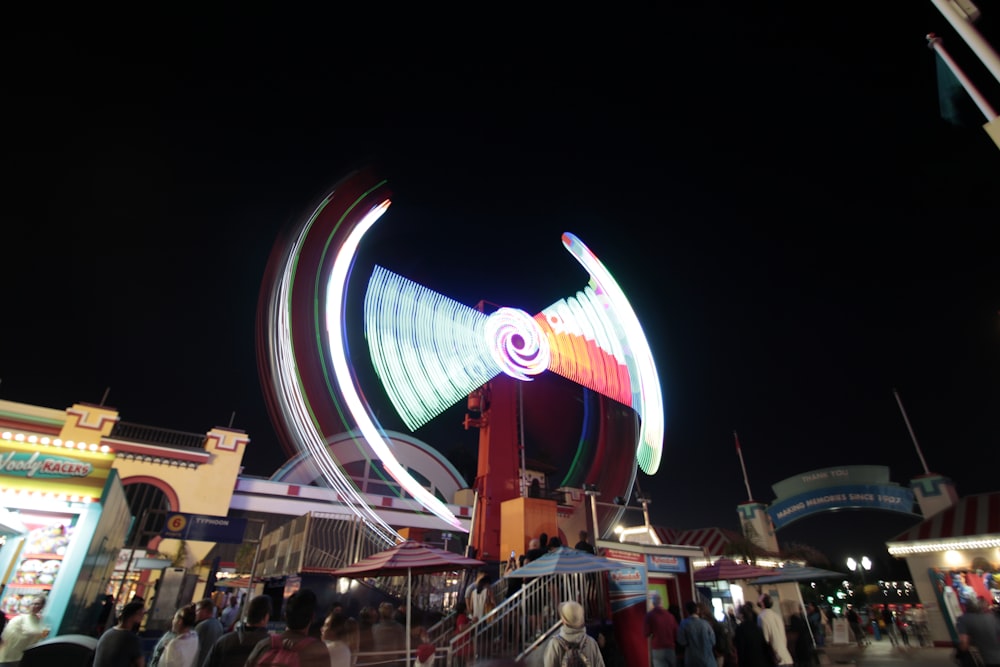 people standing in front of stalls at night