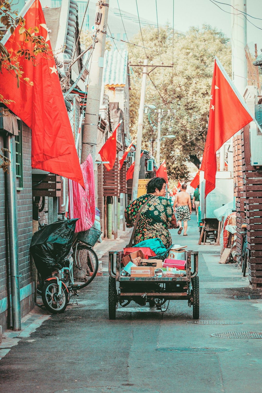 man riding auto-rickshaw between buildings
