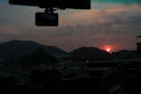 Scenic highway view with a car equipped with a Vistara dash cam driving into the sunset.
