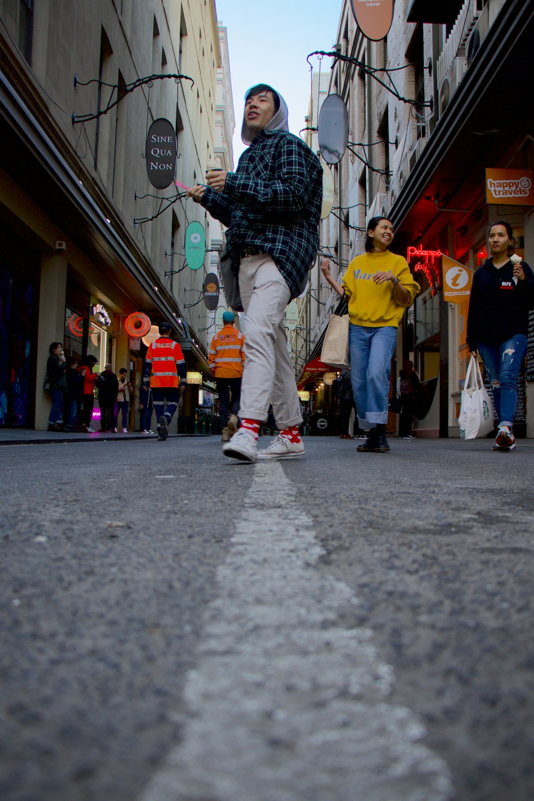 people on road between buildings