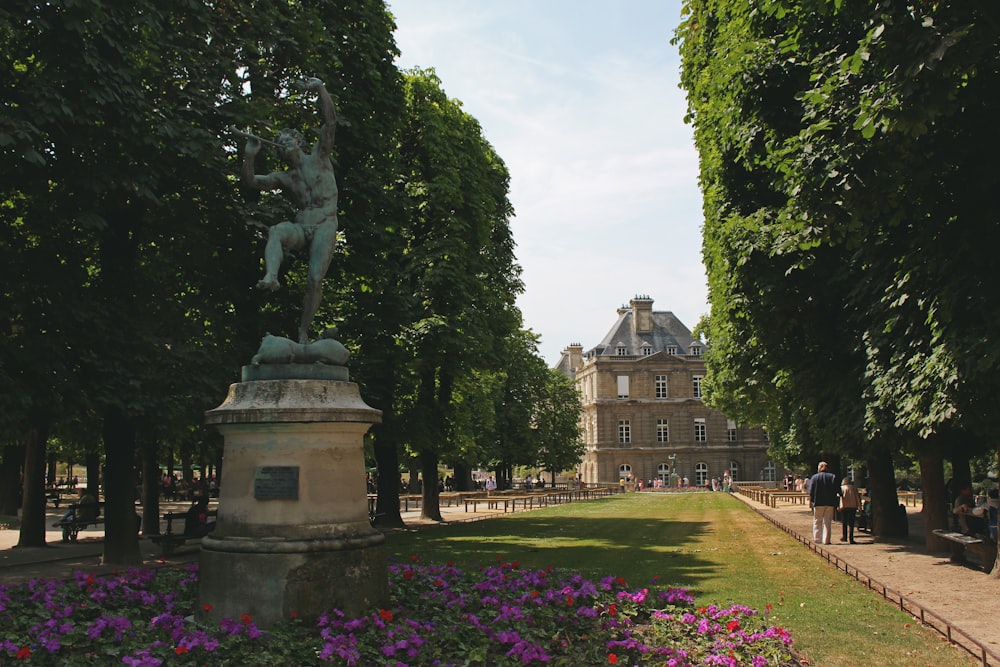 gray concrete statue and garden scenery