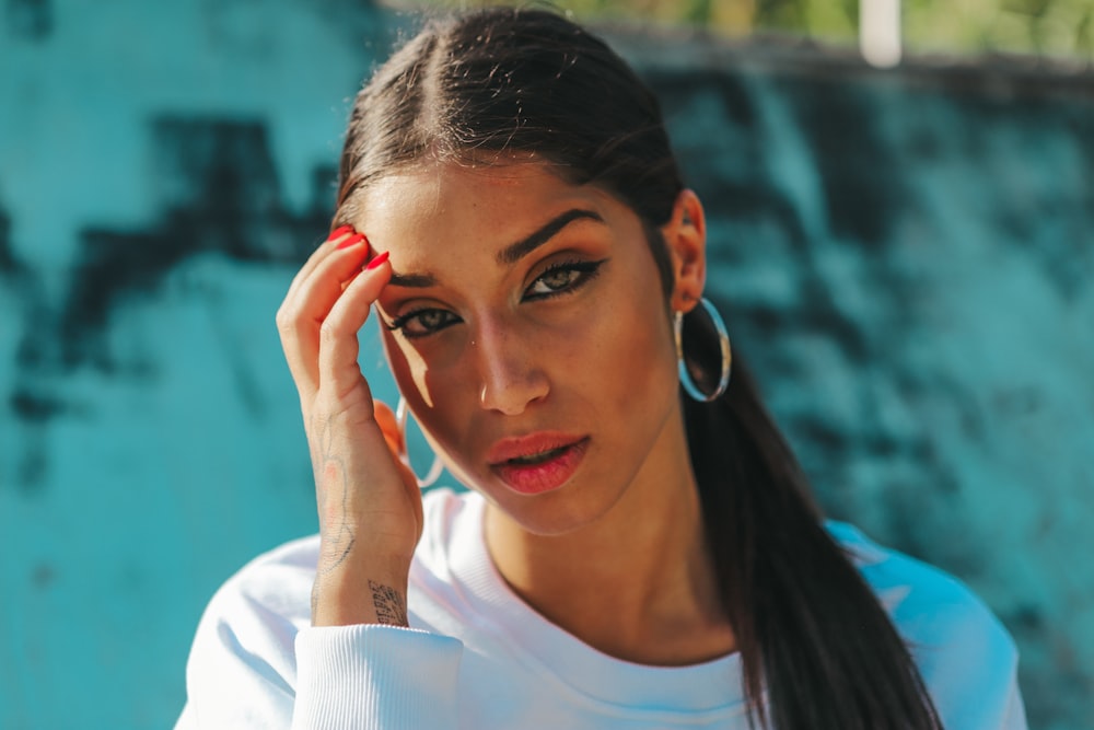 woman wearing silver-colored hoop earrings