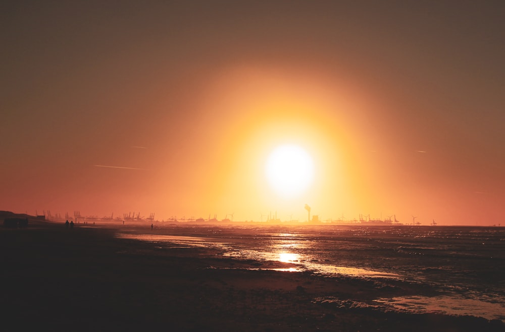 seashore under orange sky