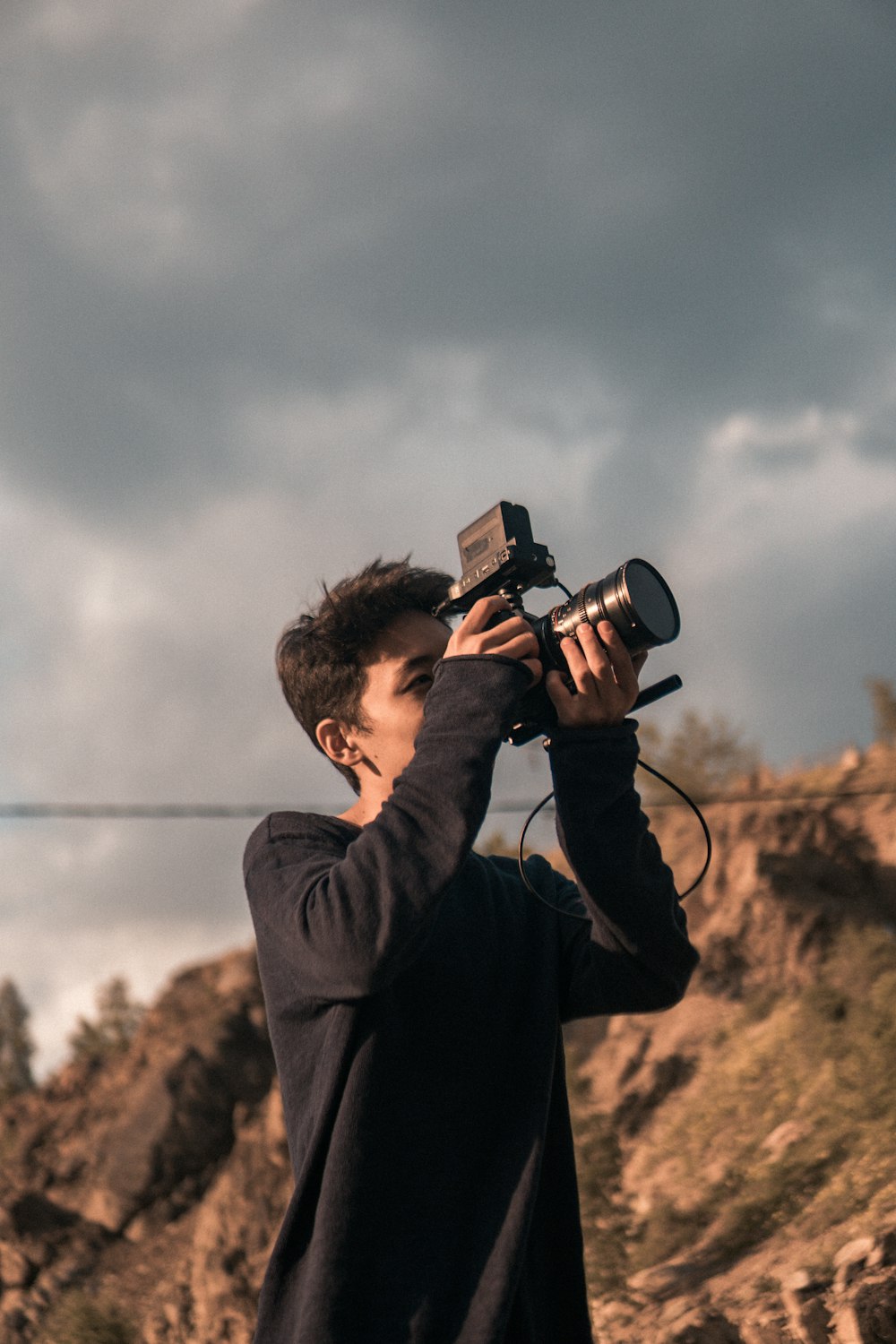 close-up photography of man taking photo near outdoor during daytime