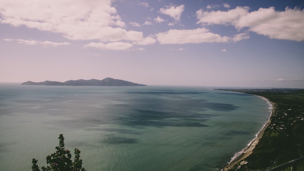 aerial photography of blue sea under a cloudy sky during daytime