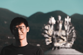 Illustration of a smiling scientist holding a glowing test tube with Himalayan mountains in the background.